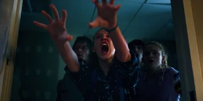 El using her powers to push the monster out of a window.