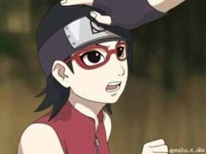 Sarada being patted on the head by her father