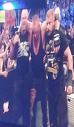 The Undertaker helped by Triple H, Road Dogg and Billy Gunn.