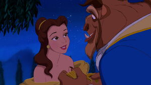 Beast smiling when Belle says she is happy at the castle.