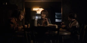 Joyce and her sons eating dinner and celebrating Christmas together.