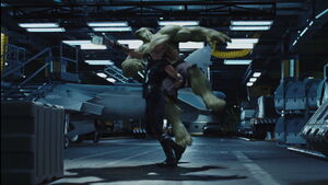 Hulk being hit by Thor with his hammer.