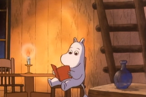 Young Moominpappa reading the book