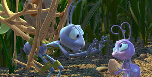 Flik gives Dot the seed lecture, using a rock.