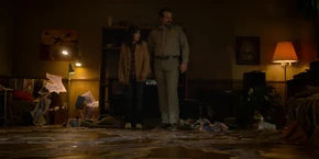 Joyce and Hopper looking at the connected drawings after they finish putting them together.