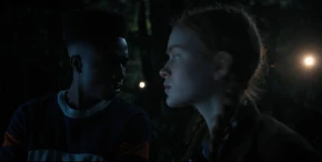 Lucas and Max turning around where they see flashlights shining behind them.