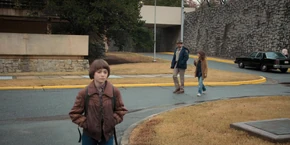 Joyce and Hopper discussing whether to trust Owens as they leave the lab.