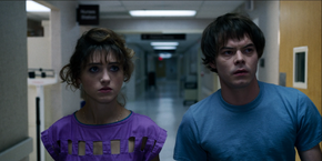 After exiting the elevator, Jonathan and Nancy walk through a hallway to get to Mrs. Driscoll's room.