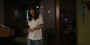 Joyce going to the kitchen after Jonathan leaves to go work at his job.