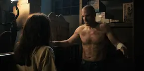 Joyce being reassured by Hopper that his bruises and scars are nothing to worry about.