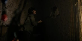 After the portal disappears, Joyce begins destroying the wall with a sledgehammer.