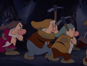 Grumpy following the dwarfs to attack the intruder.