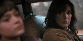 Joyce looking at Will as they drive to Hawkins Lab.