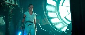 Rey staring Kylo in the Death Star ruins.