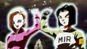 Android 18 and Android 17 giving their energy to Goku.