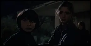 Joyce watching Nancy notice El is wearing a dress that belongs to her.