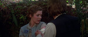 Han tending to Princess Leia after the battle of Endor.