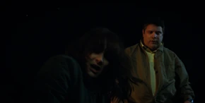 Joyce and Bob seeing the vines writhe away, revealing an open hole.