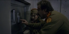 Joyce watching Hopper type Planck's Constant to get the keys from the vault after Suzie gives the number at the end of the duet.