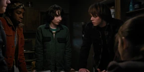 Lucas listening to Mike saying he's unsure how long it will take for El to recover.