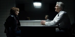 Joyce listening to Brenner describe the Demogorgon's behavior.