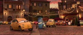 During a family celebration, Guido flirts with a yellow female car, causing Luigi to be jealous.