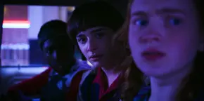 Lucas, Will, and Max spotting Billy's car, ready to run them over if they try to escape as he removed their car's ignition cable.