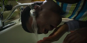 Lucas washing his face to clean off the hairspray.