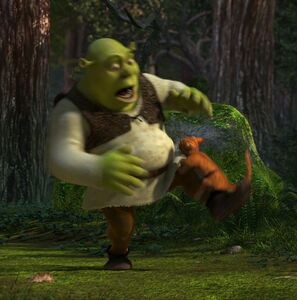 Shrek screaming comically as he is being attacked by Puss in Boots
