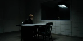 Joyce restrained in a interrogation room after getting captured.