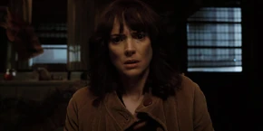 Joyce in deep thought when Mike points out that Will could be killed if the gate is closed due to being possessed by the Mind Flayer.