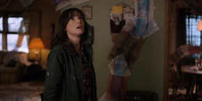 Joyce looking up as Bob explains the lines aren't road, but act like they are as they are avoiding masses of water.