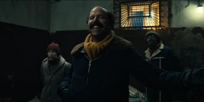 Joyce, Murray, and Yuri waiting to meet Warden Melnikov after arriving at the prison.