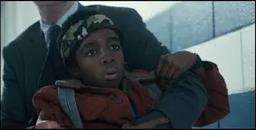 Lucas startled upon hearing a wall beginning to crack and Mike saying blood, making him realize the monster, the Demogorgon is coming.