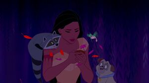 Pocahontas looks at the compass with her friends.