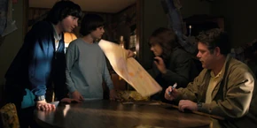 Joyce taking Bob's map so she can get to Hopper's location and save him.