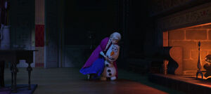 Anna being helped up by Olaf as he carries her to the fireplace.