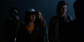 Lucas watching Dustin ask Nancy and Jonathan if Mike and Will are not in the lab.