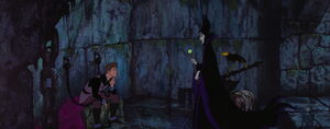 An imprisoned Phillip being visited by Maleficent.