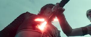 In an act of rage, Rey impales Kylo Ren, ending their duel.