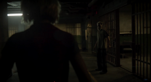 Strauss is watching Maya arriving at the cell block after exiting his cell room.