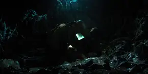 Joyce and Hopper having put Will on the ground after they free him from the vine.