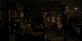 Joyce checking a light, only to see it not blinking like it was the last time Will spoke to her.