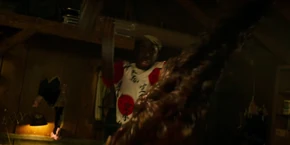 Lucas chopping the Mind Flayer's tentacle with an axe.