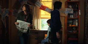 Joyce and Mike going to look over the drawings to see which one matches the one Will just drew.