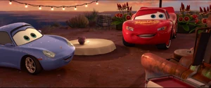 McQueen and Sally surprised to see Mater posing as their waiter.