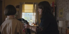 Later, Joyce helps Will put on his Ghostbuster costume.