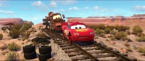 McQueen and Mater on train tracks with no tires on.
