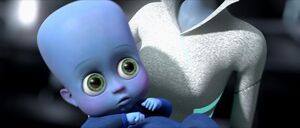 A baby Megamind held in his mother's arms.