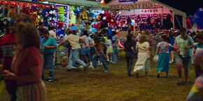 Joyce and Hopper running in a different direction when they see another Russian assassin.